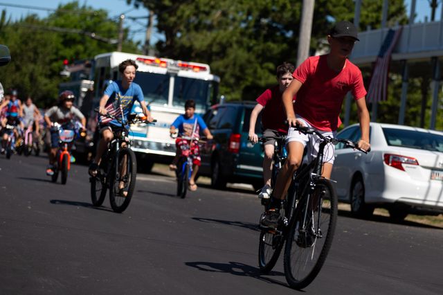 Children ride bicycles during an annual Independence Day bicycle parade Cape May Point, New Jersey, July 4th, 2022.